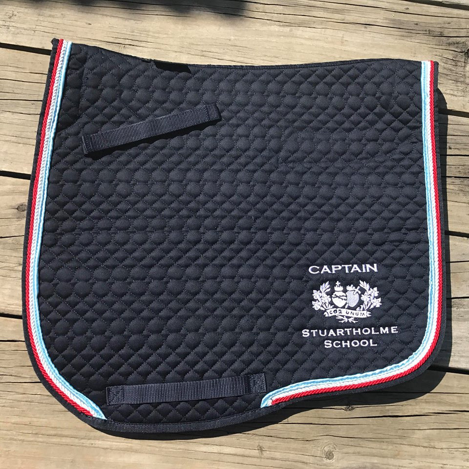 Stuartholme Saddle Pad. Cotton Quilted with rope trims and School Embroidery. There are a few different options listed in checkout, Jump or Dressage Style also some with sheepskin Extra Padding